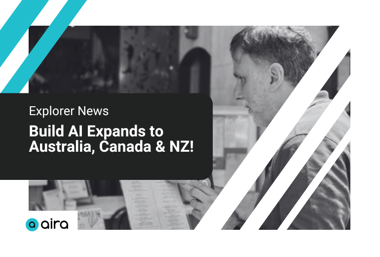 A black and white image of a man holding his cellphone with the Aira app open up to a restaurant menu. Text reads "Explorer News: Build AI Expands to Australia, Canada & NZ!" Decorative teal and white lines at top corners, and the Aira logo in bottom left corner.