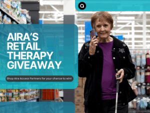 "AIRA’S RETAIL THERAPY GIVEAWAY" "Shop Aira Access Partners for your chance to win!" overlaid with Aira’s teal UI banner and a small circular "a" logo icon at the top; at right, an older woman in a purple top and black embroidered jacket smiles while holding a smartphone and a white cane in a brightly lit store aisle.