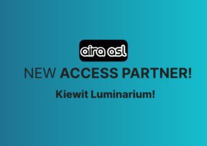 Teal background with the black and white Aira ASL logo. Text reads "New Access Partner: Kiewit Luminarium!"